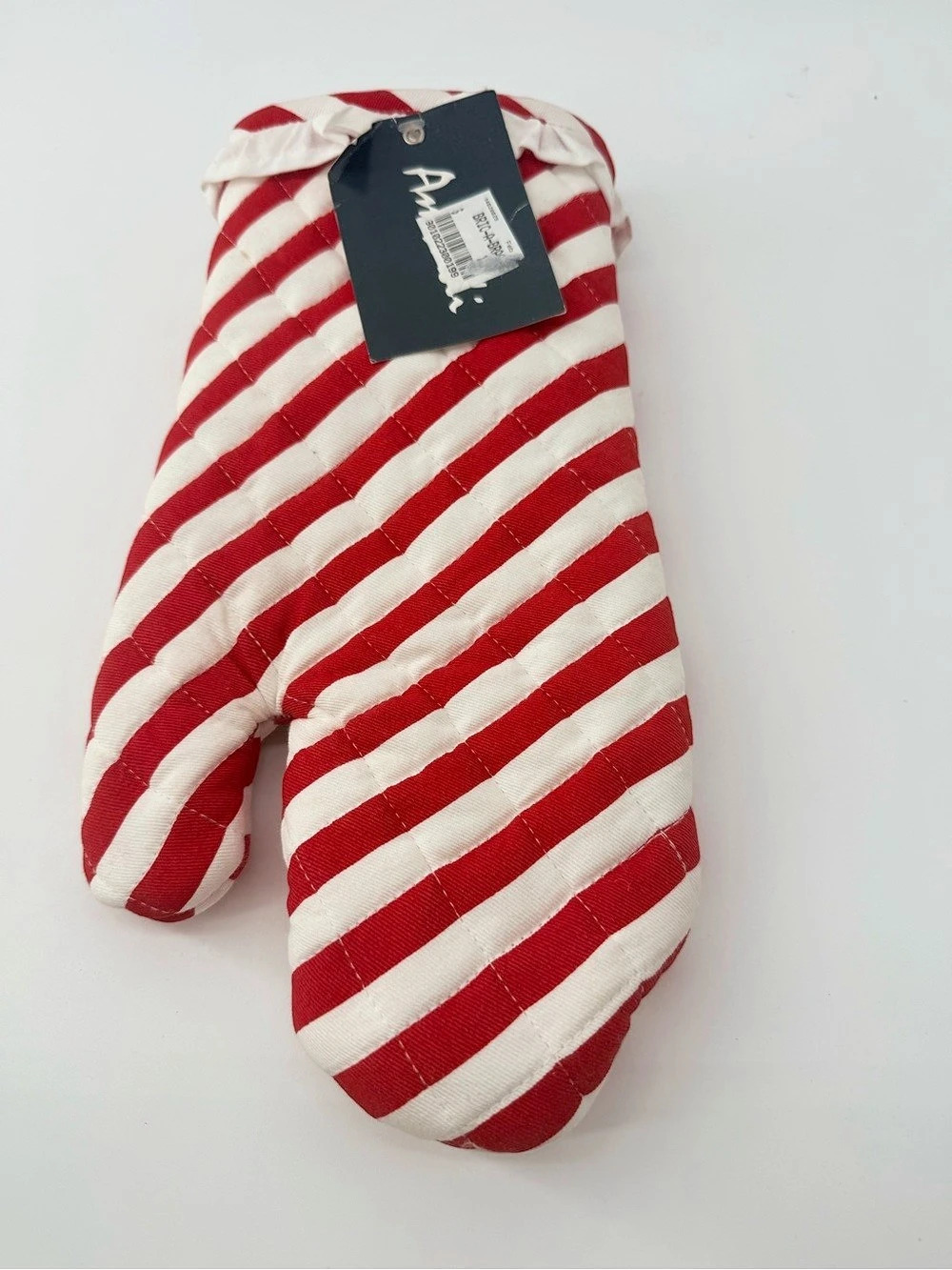 Quilted Ambadi red and white striped oven mitt.